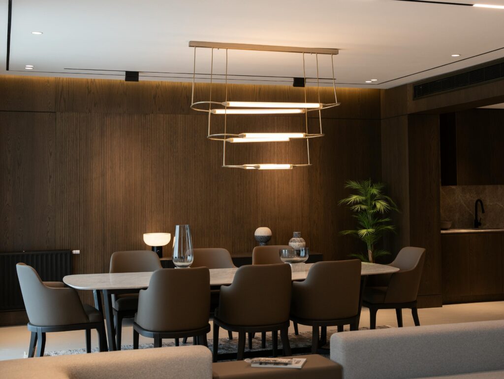 pexels-photo-27562218-27562218 Elegant dining room with modern chandelier, minimalist design, and luxury furnishings.
